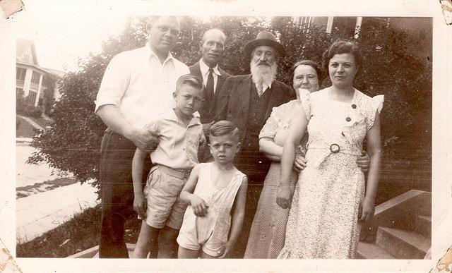 Harry Silverman holding Vernon Silverman.  Abe Kamar, Kolman Baellow, Minnie Kamar holding her daughter Betty Kamar Silverman, and youngest child Burton Silverman in Minneapolis, MN.