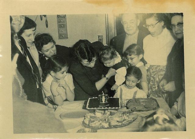 Hike Cohn Schulman holding Lori Beth Schulman at her first birthday party. See notes.