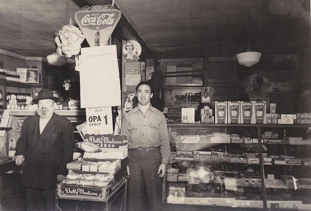 Sol Cohen (right) and his father (left) in their grocery store.