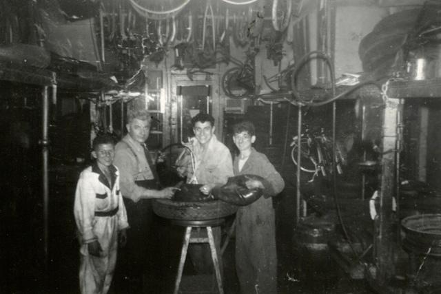 Joe and Cal Steinlauf in the middle at the bike or tire shop