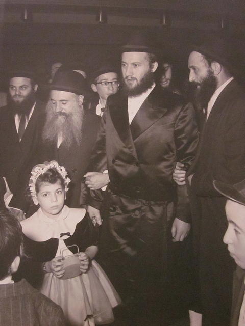 Zev Strohli being walked down the isle by Shloime Weiss