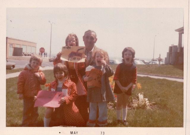 Markus Weisz holding Rivka Weiss Goldstein (L to R) Yitzi Weiss, Miriam Weiss Anton, and Rachel Weiss Feit, ?, May 1973