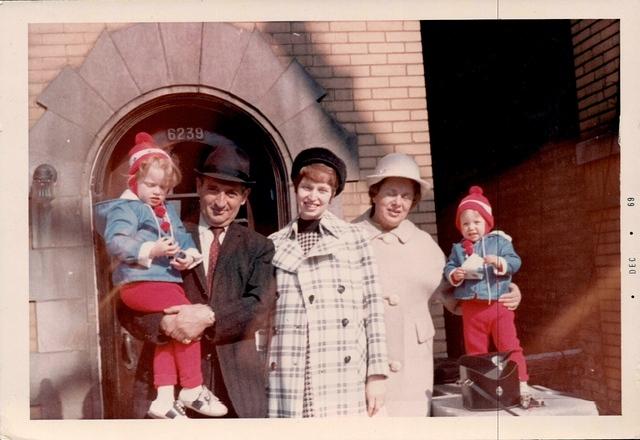 Markus Weisz holding Rivka Weiss Goldstein, Joyce Steinlauf Corcia, Annie Rubin Weisz, and Miriam Weiss Anton