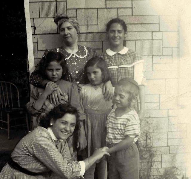 Rivka Ganz Weiss holding Faigy Weiss Rosenberg and Chaya Leah Weiss Weisz (in the middle), Gittie Gitty Weisz Appeldorder, and Miriam Weiss Strohli holding Yitzchak Isaac Weiss hand. Abt 1945