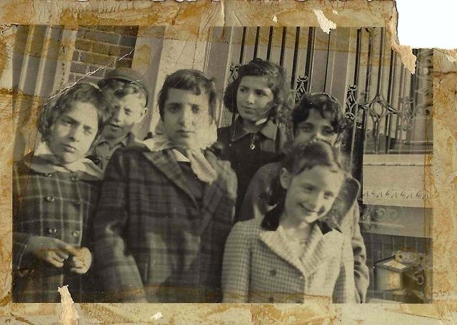 Joe Weiss and Rivka Edith Weiss (in the back) and Flo Weiss Rossof (front right) with friends in Williamsburg, NY. 1945.