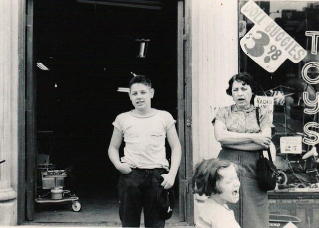 Eddie Steinlauf, Joyce Steinlauf Corcia, and Esther Yellen Steinlauf in front of bike store