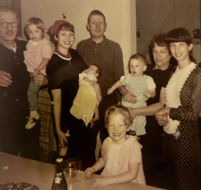 Maurice Steinlauf holding Miriam Weiss Anton, Joyce Steinlauf Corcia holding Rachel Weiss Feit, Joe Weiss, Esther Yellen Steinlauf holding Eddie's son, Shlomo, and Nechama Brandwein Steinlauf, Rivka Weiss Goldstein at the table