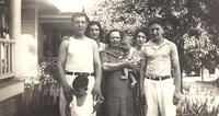 Morris, Sarah Baellow Dubin, Bala Komar Baellow holding Norman, Esther Baellow Levinson, and Milton. Leon Baellow standing in front of Morris. Taken in front yard at 2006 E. 30th St., KCMO.