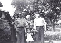 Morris & Bala Komar Baellow in the middle flanked by Gladys Weiss Baellow on the left & Milton Baellow on the right.  Bala is holding her granddaughter, Roberta (Bobby Sue) Baellow Travis