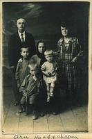 Mema Charna sitting, son Aaron and his wife and three children