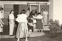 Shirley Cohn Levine and Arnold Levine in the doorway, Virginia and Martin Cohn on the porch