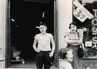 Eddie Steinlauf, Joyce Steinlauf Corcia, and Esther Yellen Steinlauf in front of bike store