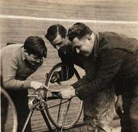 Fred, Dave, and Joe Steinlauf working on a bike