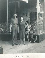 Maurice Steinlauf and Esther Yellen Steinlauf in front of the bike store