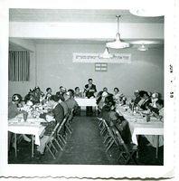 Oscar Dubin leading giant family seder, 1958.  See notes.